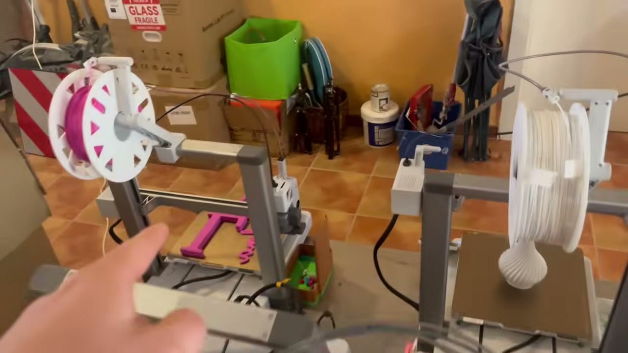 Impresora 3D en un taller con bobinas de filamento cerca